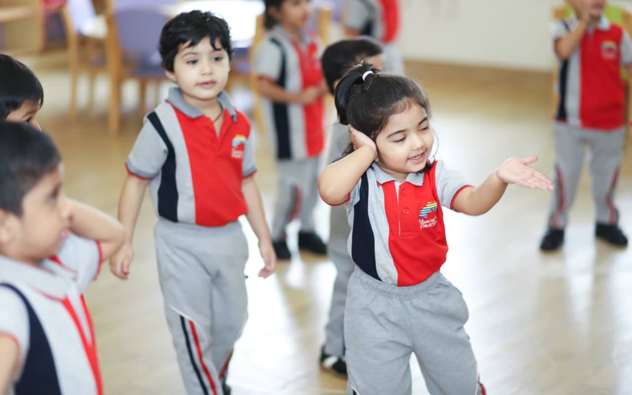 Young children engaging in indoor play activities at a pre-nursery school.